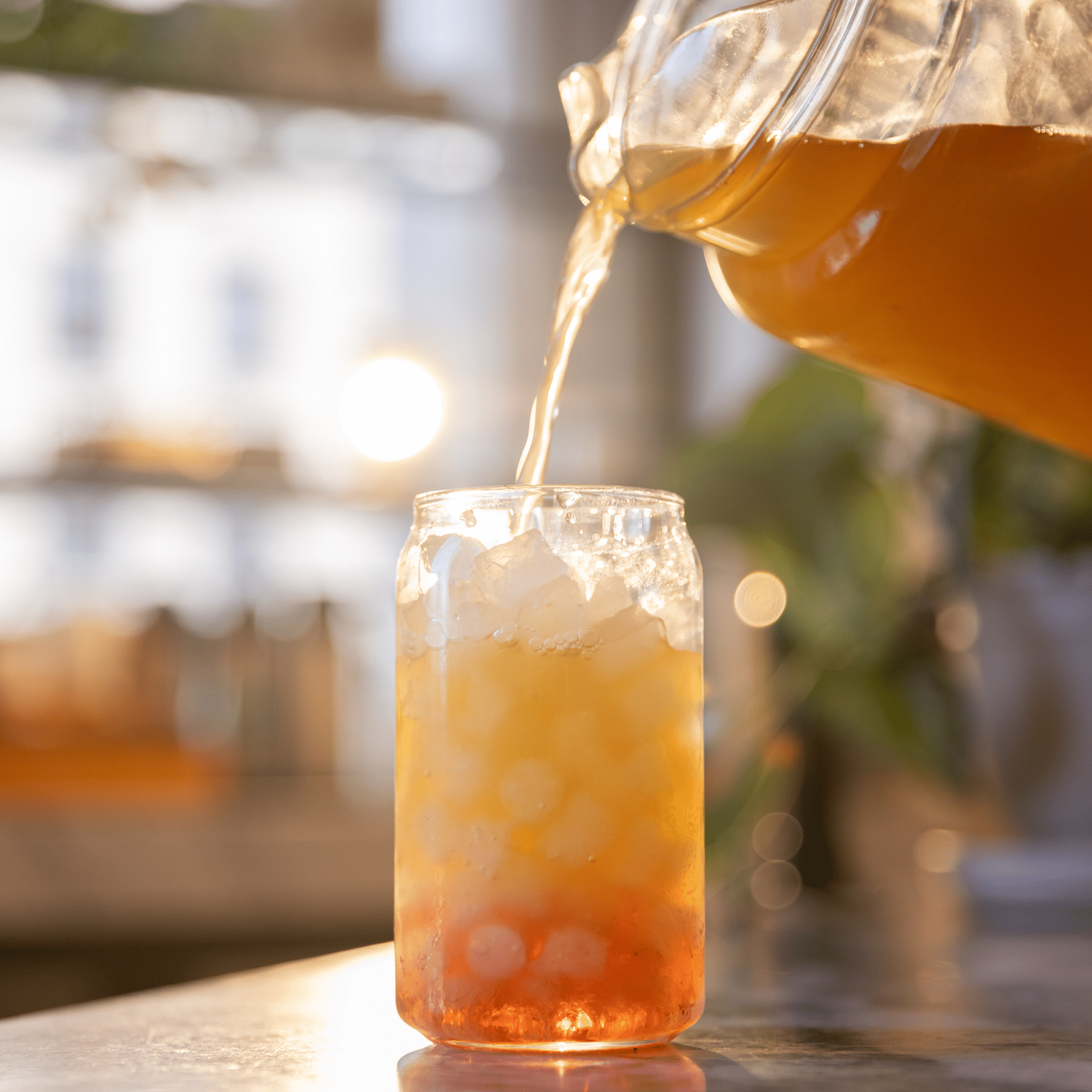 Iced tea pour into glass cup, pouring tea