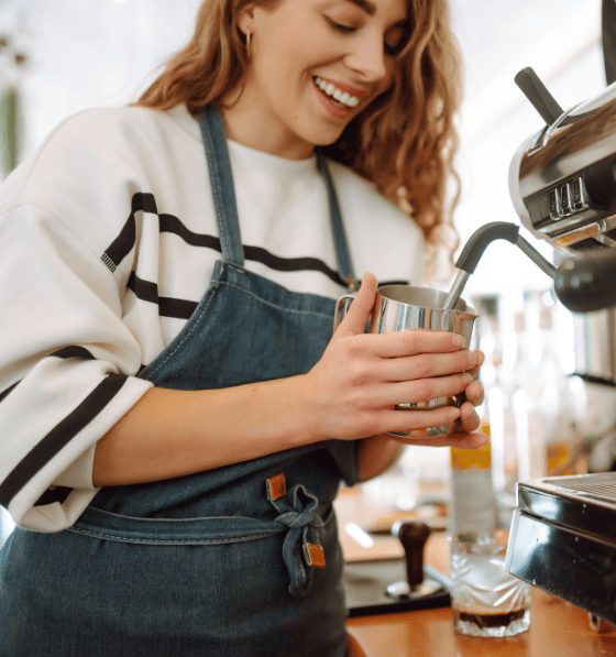 Barista using coffee machine, ptwmt coffee solutions, barista steaming milk
