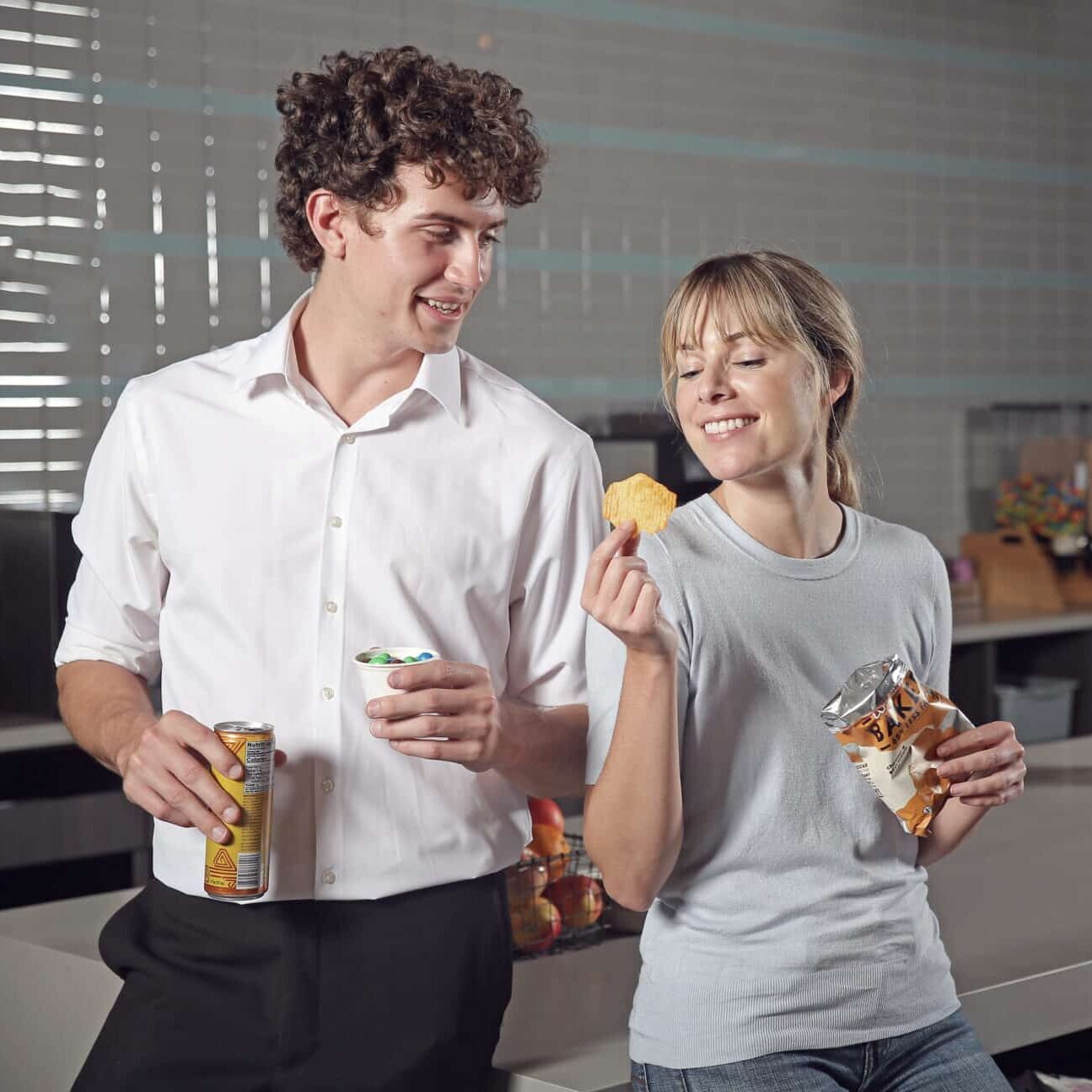 Two employees eating snacks, breakroom food service solutions, snacks and beverages