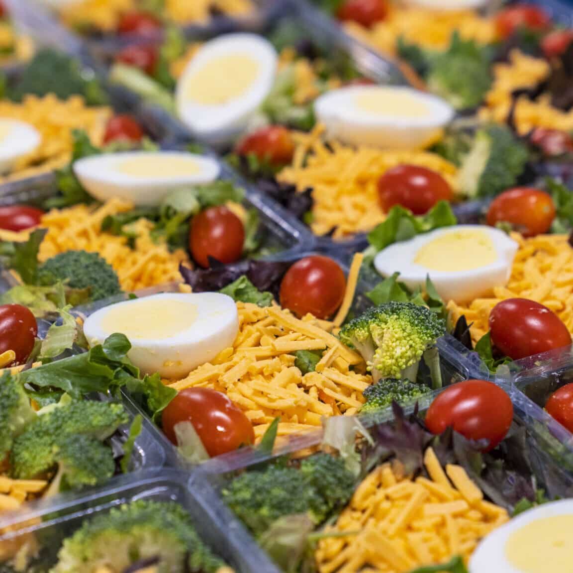 Garden salad being packaged, grab-and-go meals, fresh food for workplaces
