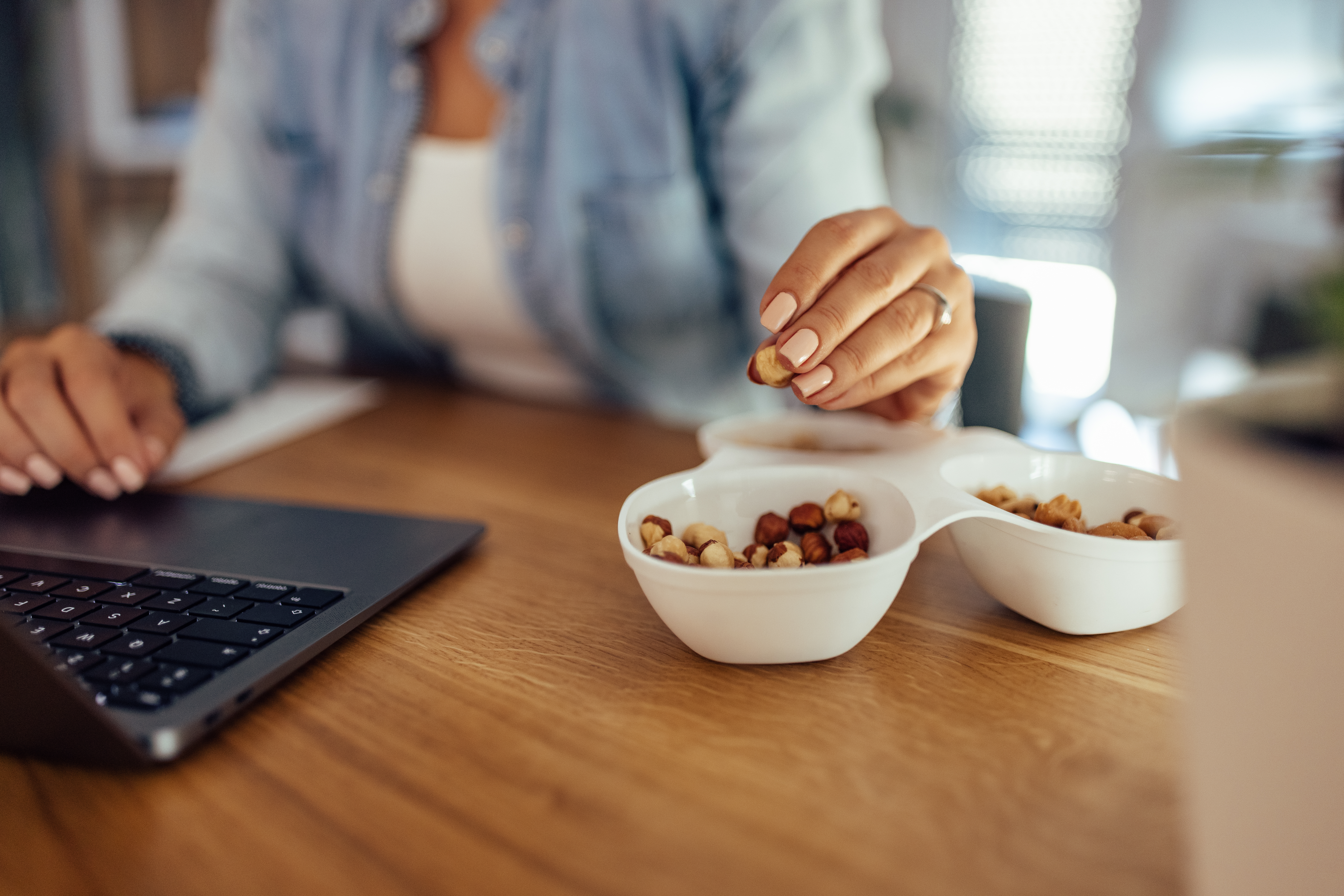 Businesswoman having a snack while working, close-up