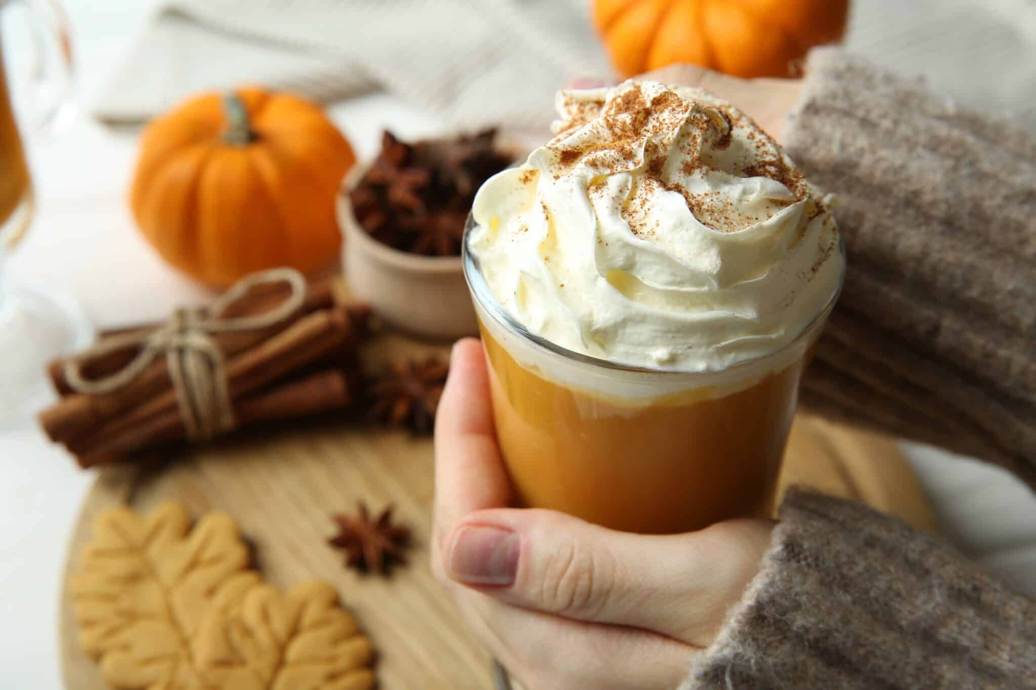 Person holding pumpkin spice latte